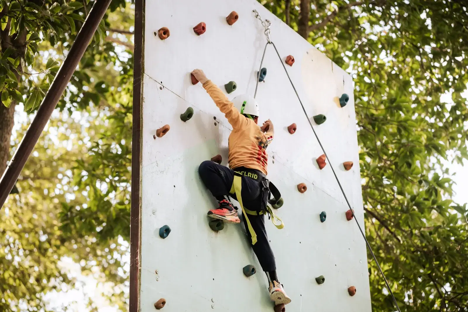 Young climber on the natural-look climbing wall at Ban Jungle Adventures, Kathmandu