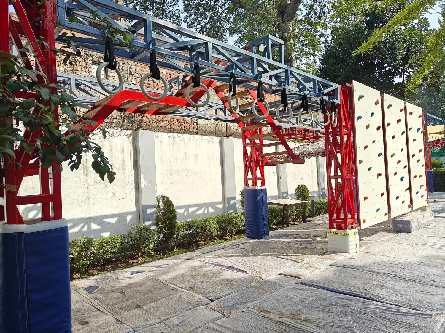 Suspended course with climbing wall panels along the memorial walkway