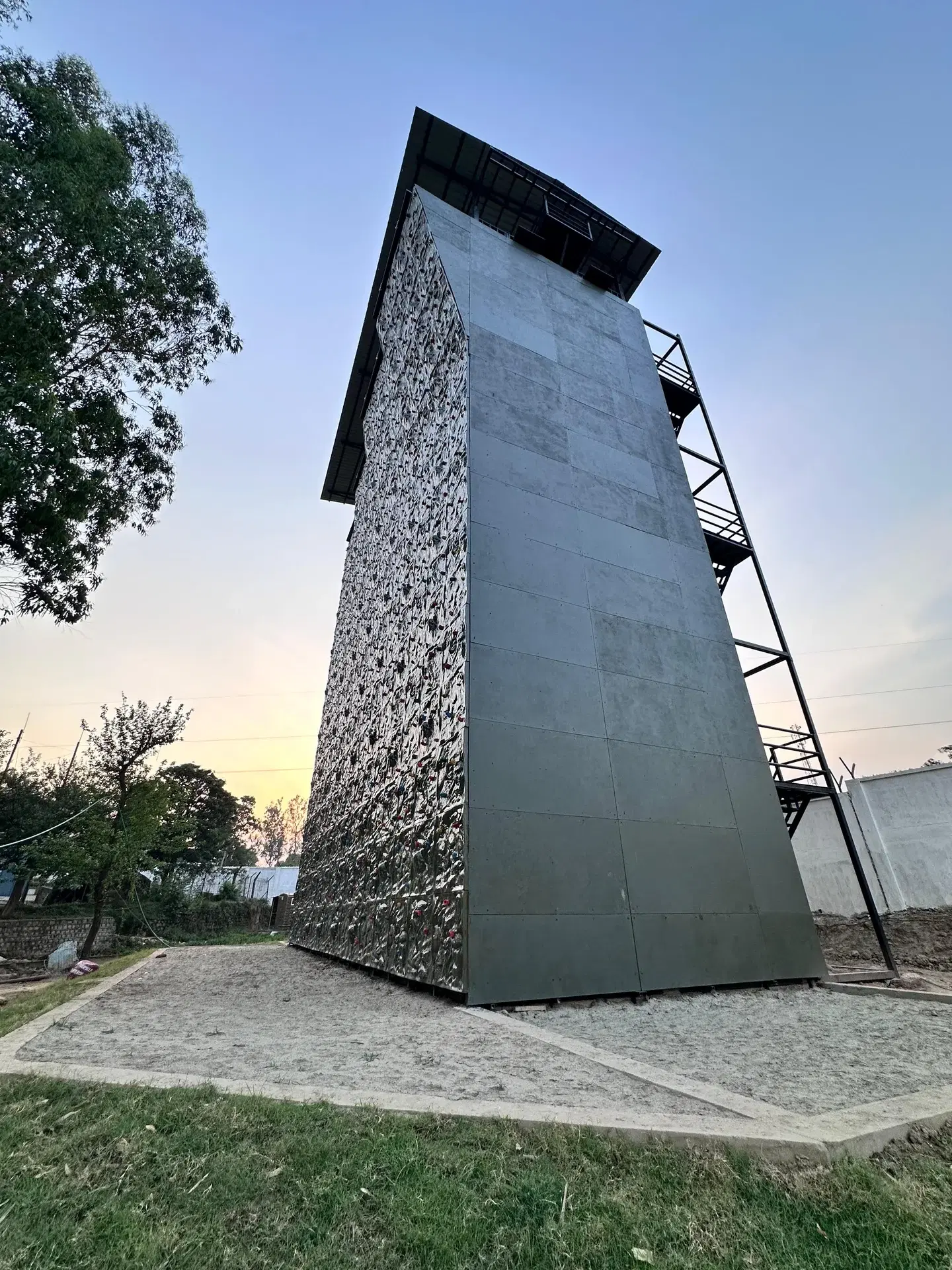 OXO Planet climbing tower structure at 9 Para, Udhampur, low-angle dusk view