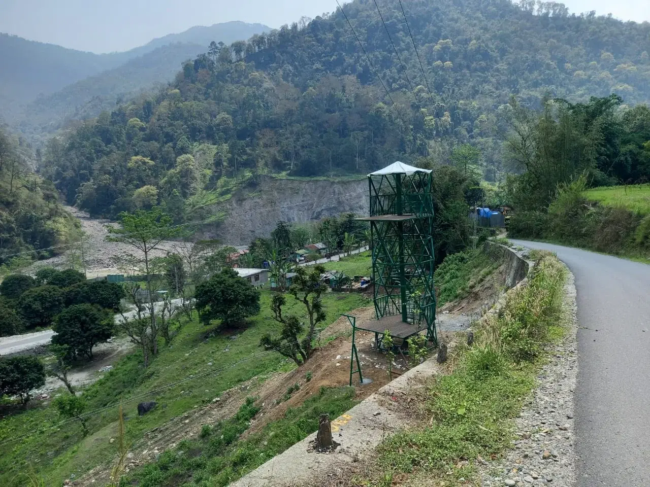 Green zipline tower on the hillside at Kitchidumra Biodiversity Park