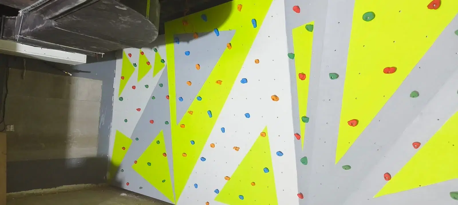 Bouldering holds on the geometric climbing wall at Fitkits Gym