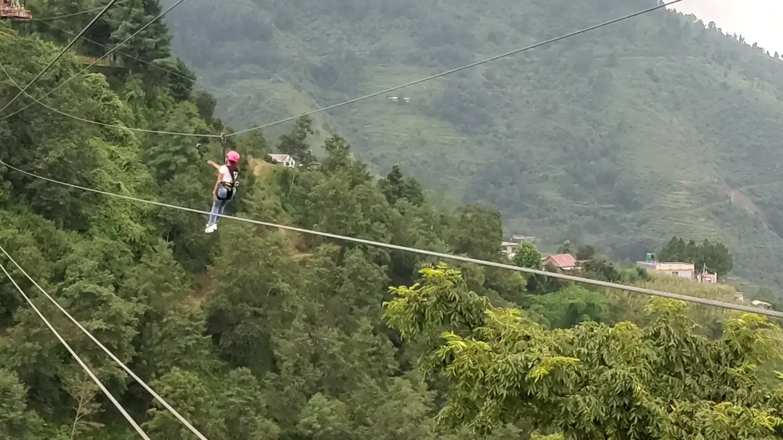 Rider on the 1,200 m zipline over forest valley at YOYO Adventure Park