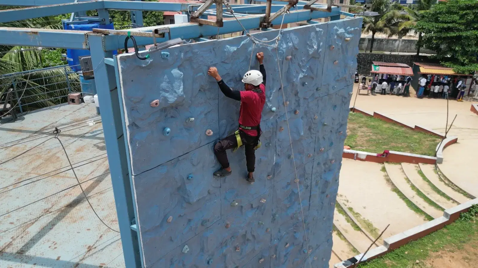 Climber on the Teammanthras tower climbing wall, Panambur Beach