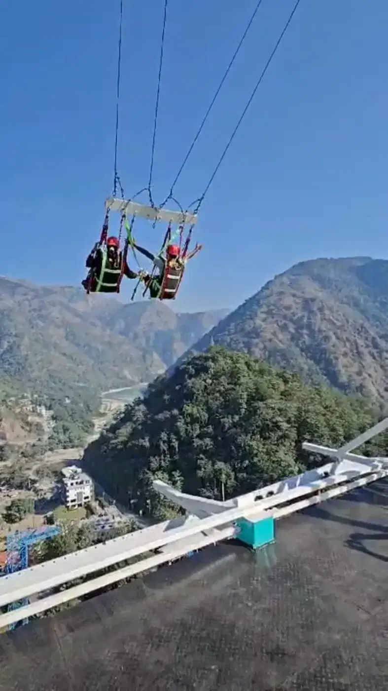 Giant swing riders sweeping above the sky walk at D Splash