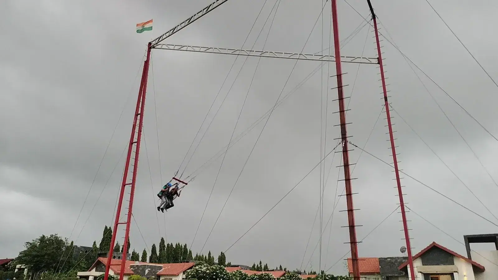Giant swing riders mid-air at Prabhu Farms adventure zone