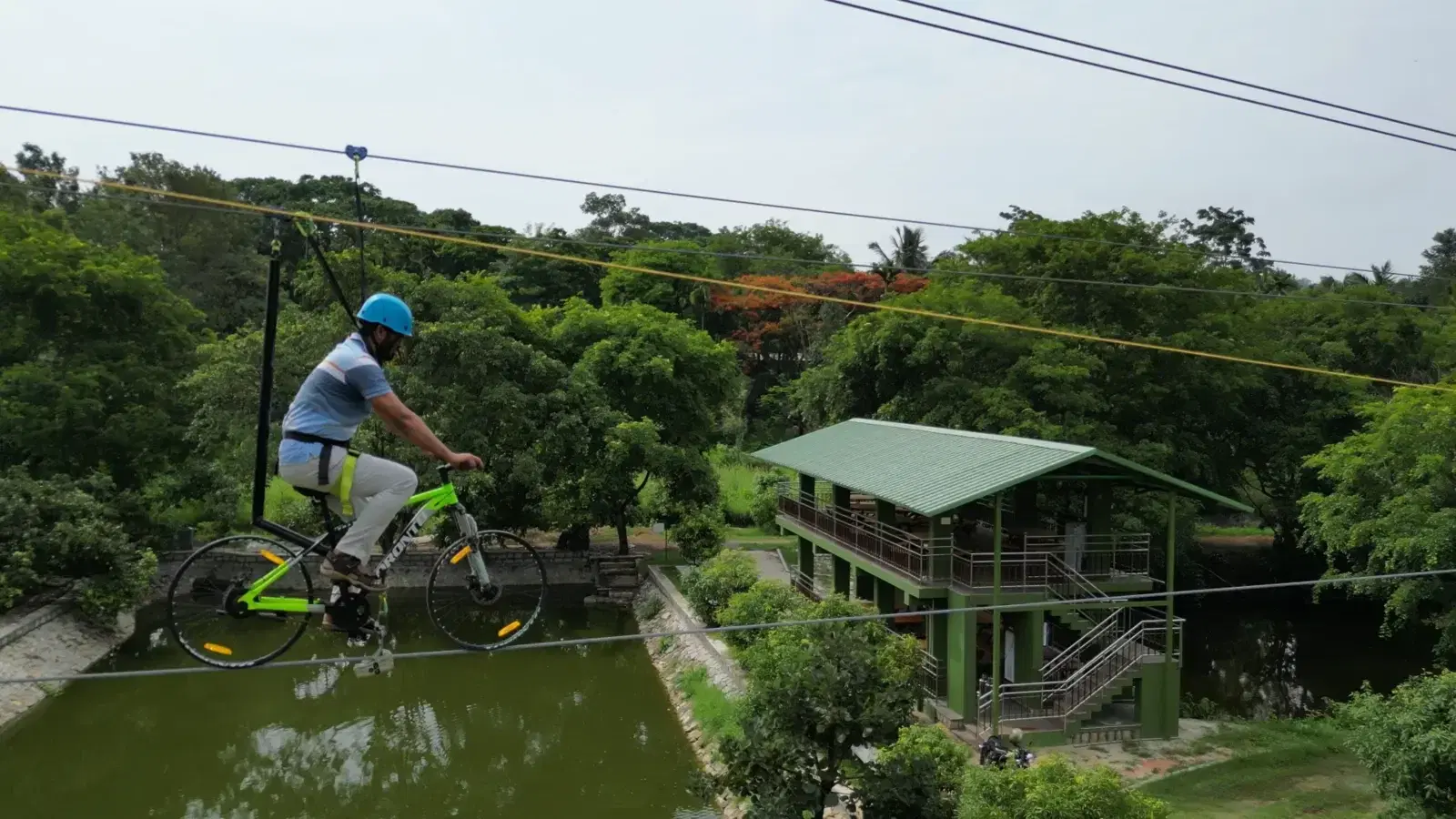 Sky cycle rider crossing over the pond at Vasnudaraa Farms, Bannerghatta