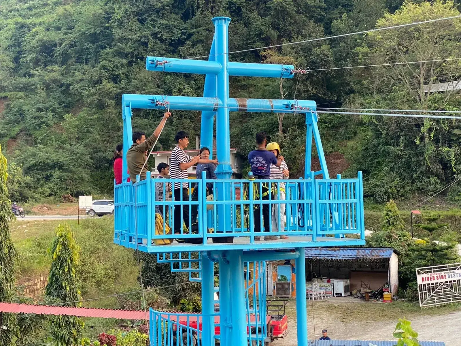 Blue steel zipline tower structure at Trishuli River Resort