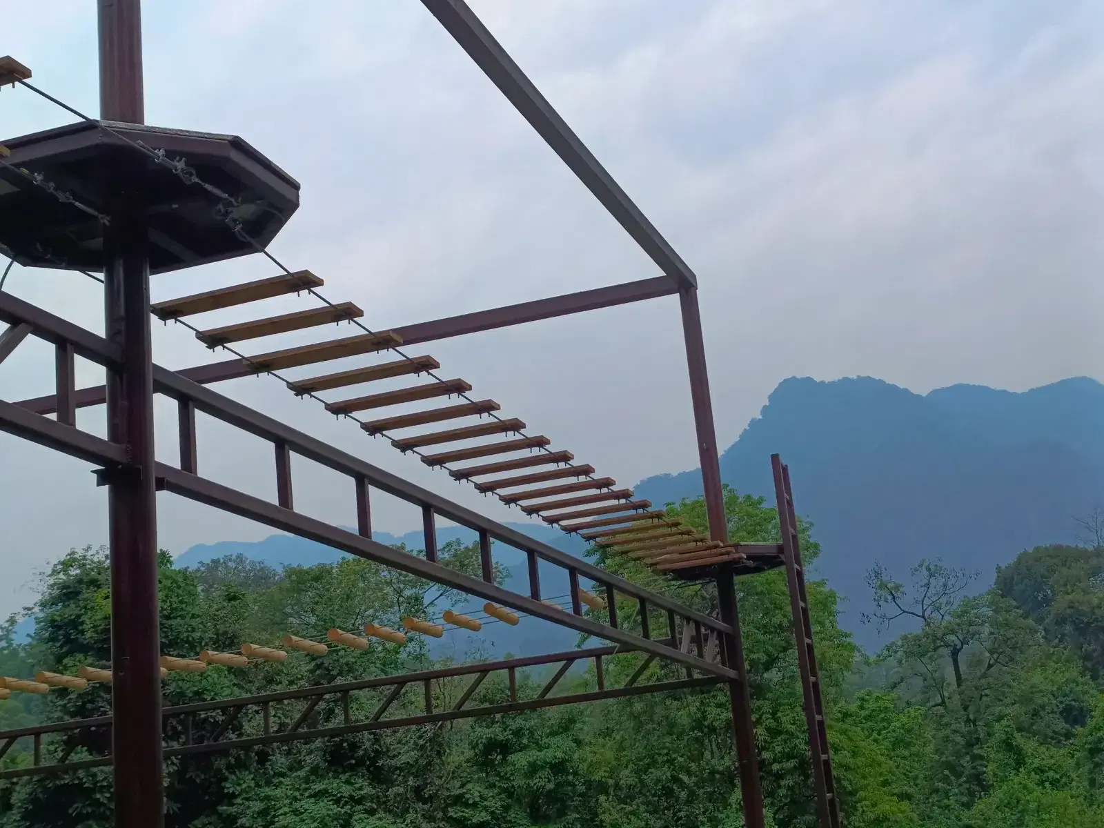 High ropes course elements with Arunachal mountains behind, Pasighat