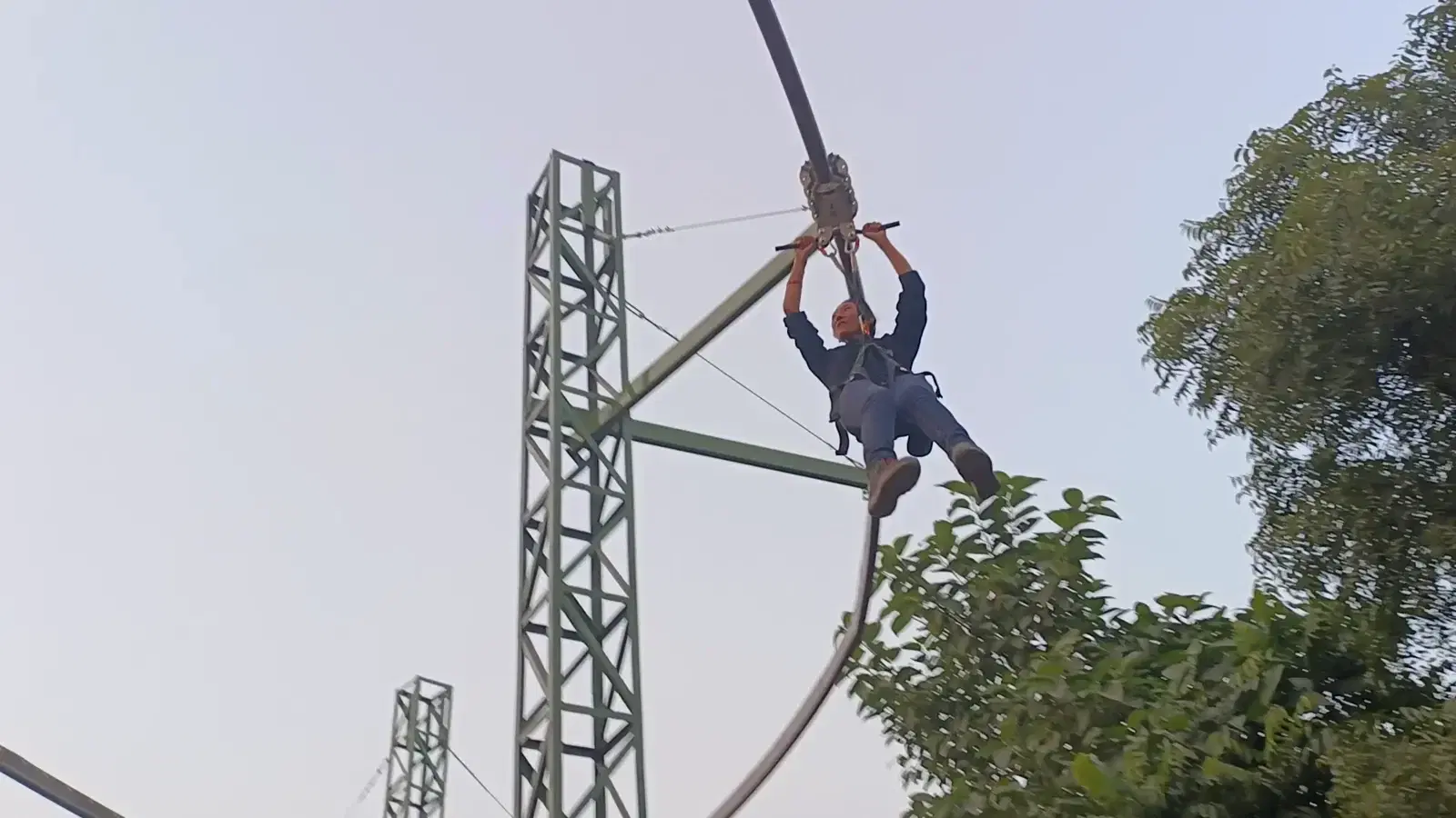 Rider on the roller coaster zipline near the lattice tower, Sonipat