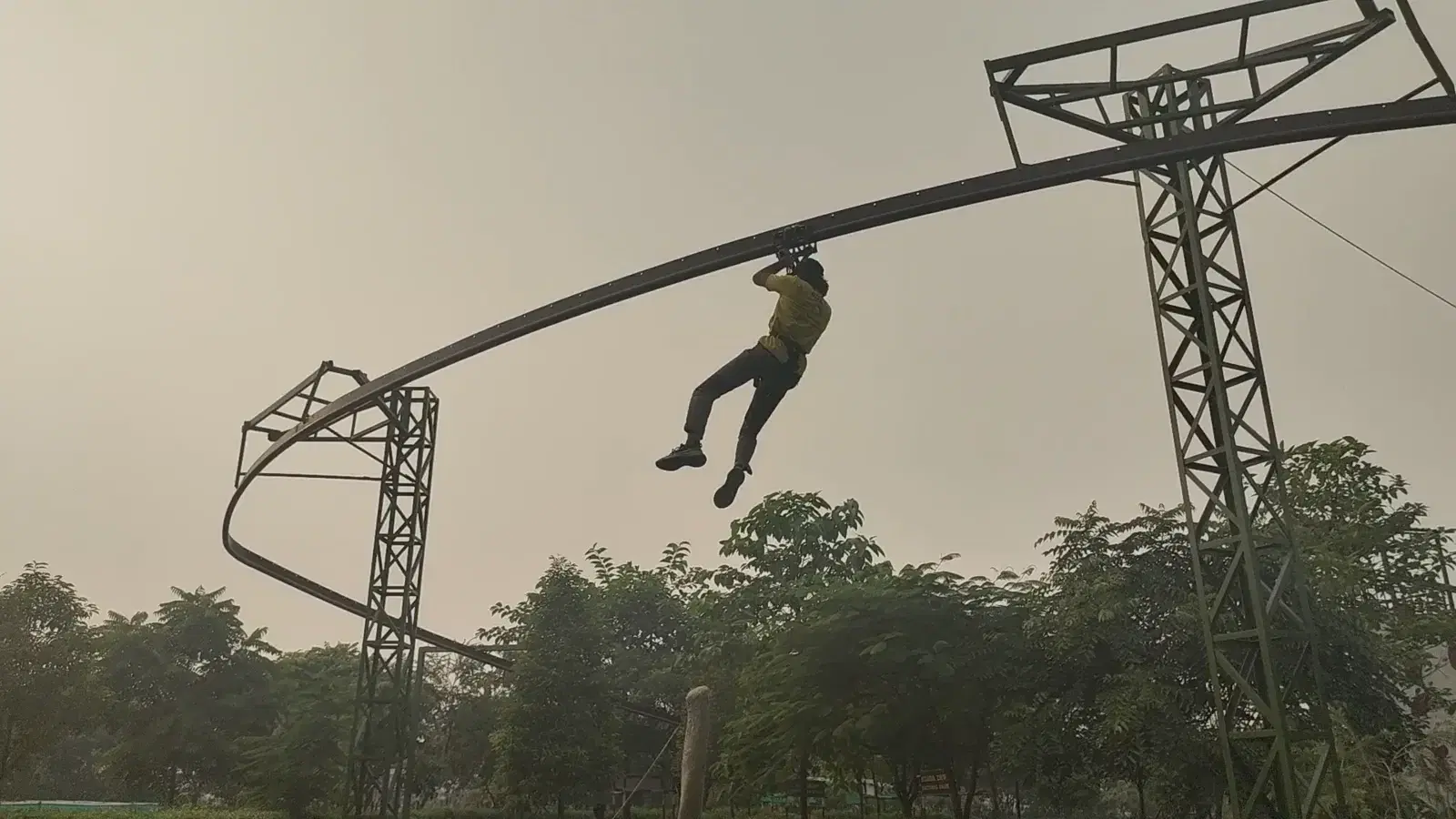 Rider descending the curved roller coaster zipline rail at Great Rocksport