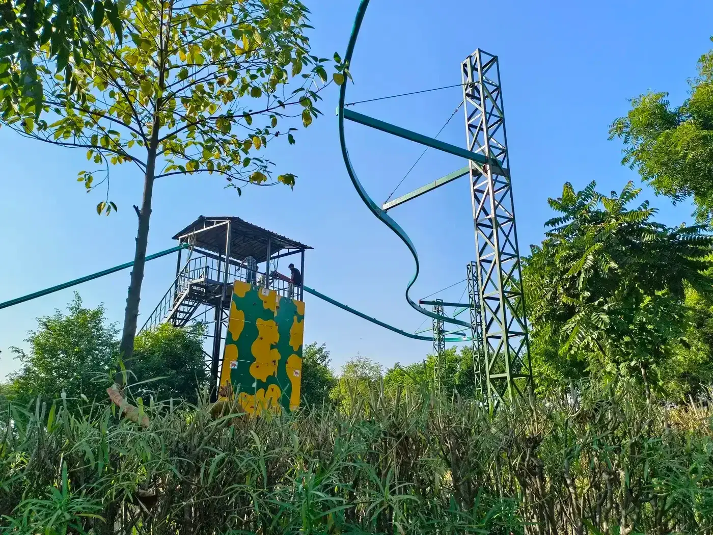 Roller coaster zipline tower with camouflage climbing wall at Great Rocksport, Sonipat