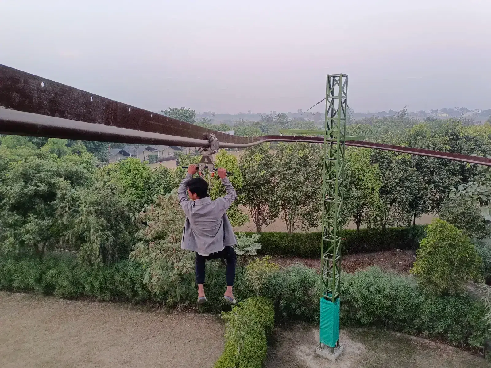 Roller coaster zipline curve section with rider at Great Rocksport, Sonipat