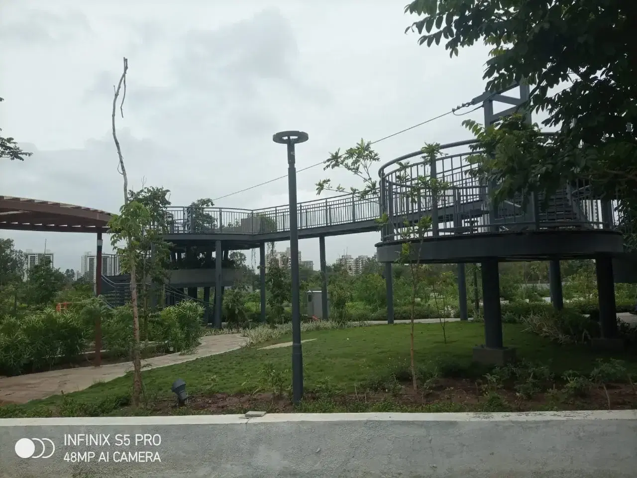 Zipline cable spanning the green play zone at Godrej Skyline