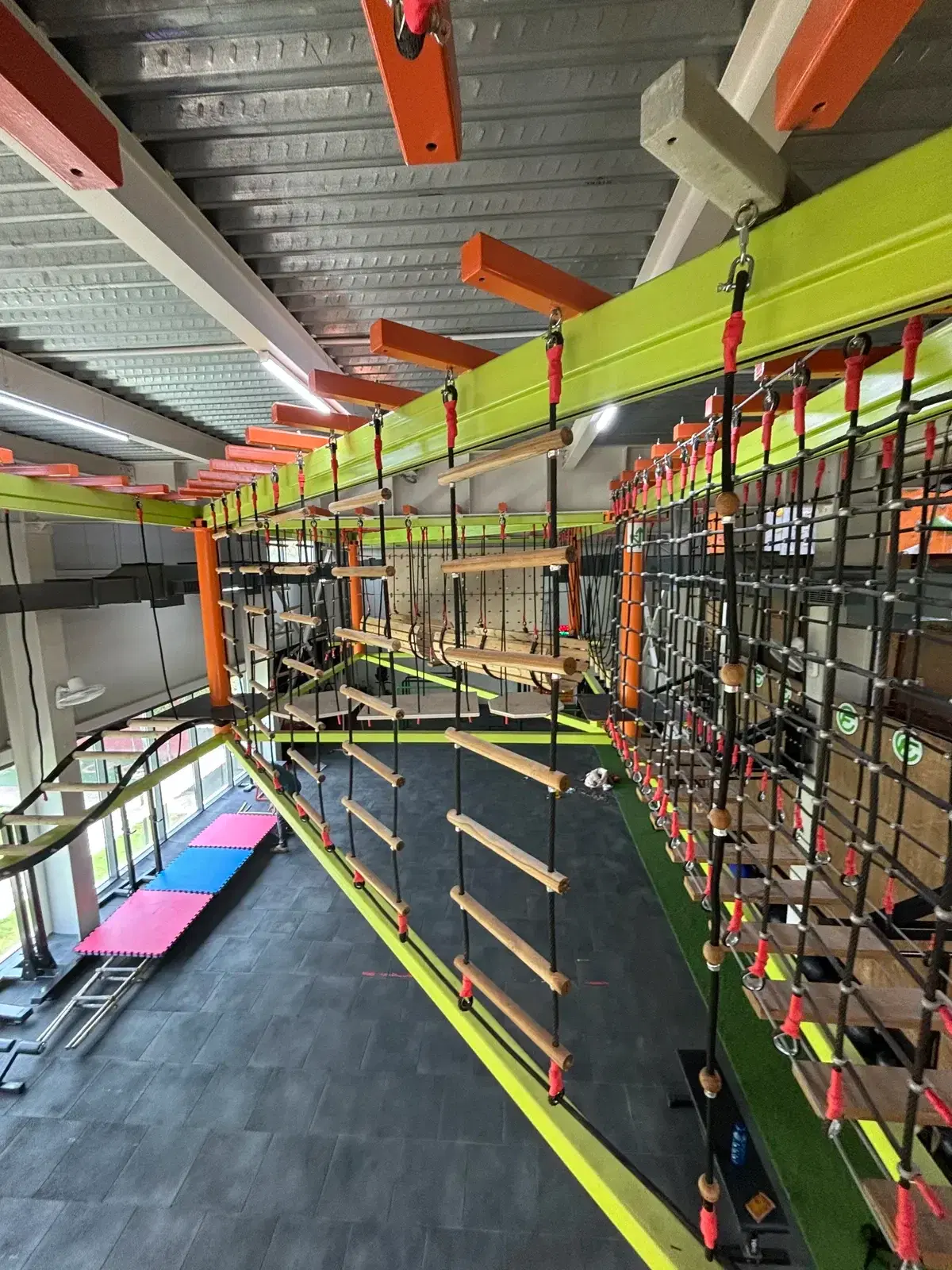Suspended ropes course hanging above the gym floor at Climb Central