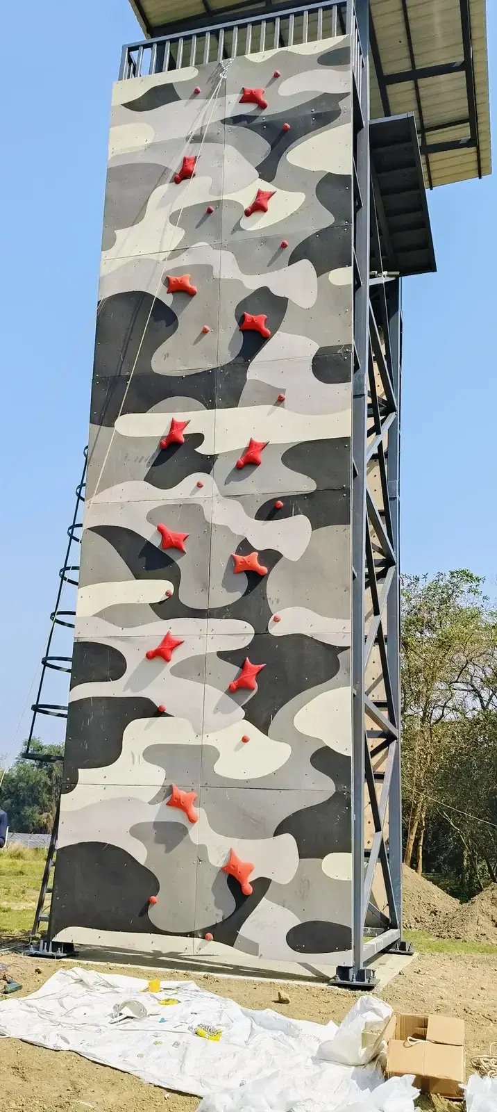 Climber on the speed climbing face with red holds at Barrackpore