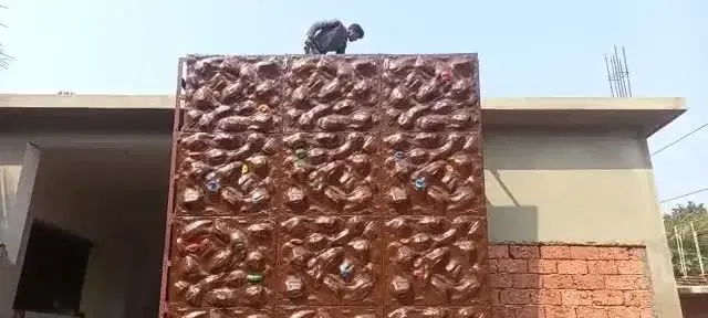 Natural rock-finish climbing wall with climber at Caniggia Farms