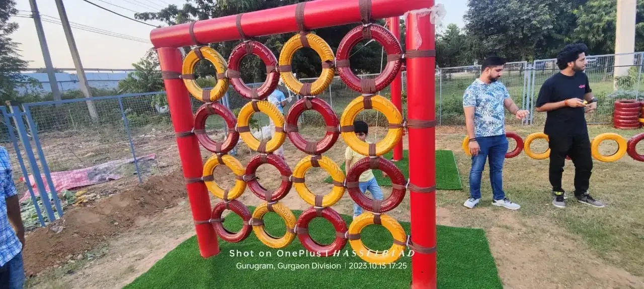 Children playing on the ring wall element at Swadhyay School, Manesar