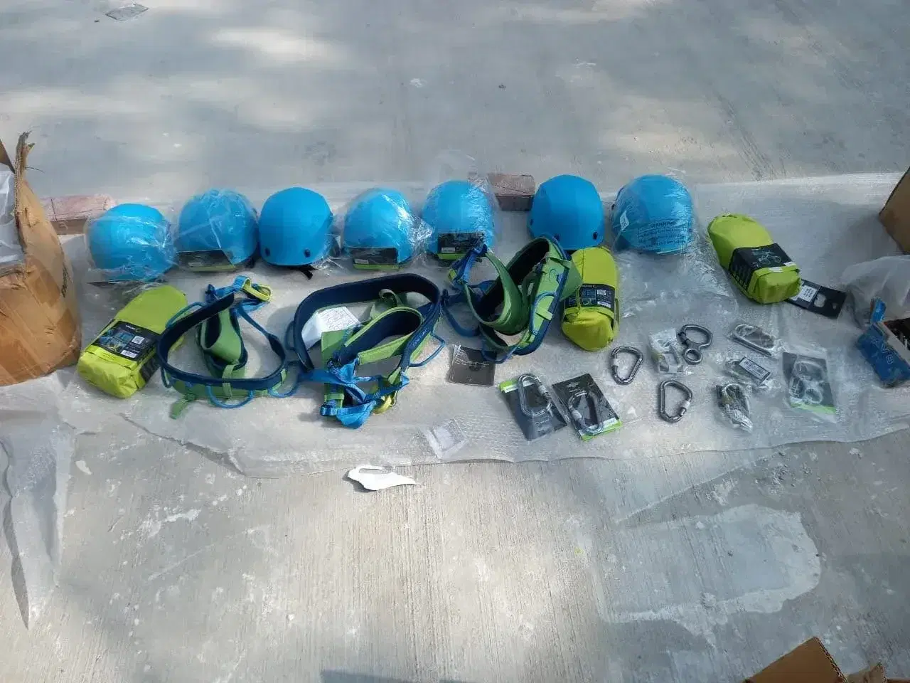 Helmets and harnesses laid out for staff operations training at Orchids School