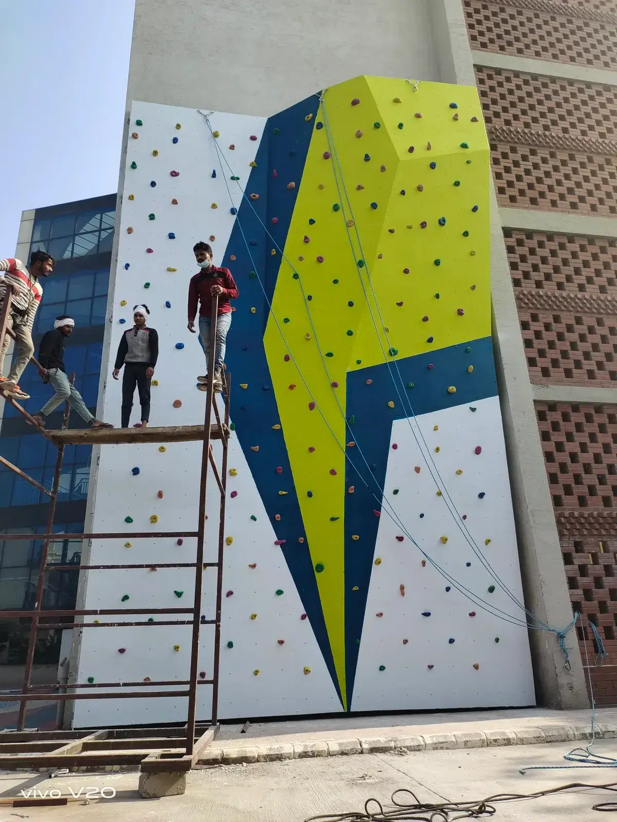 Installation crew erecting the Orchids School climbing wall