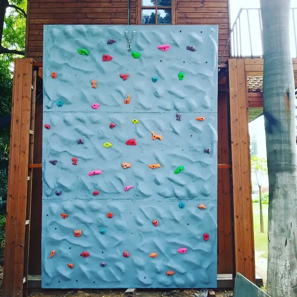 Flat beginner climbing face with colourful holds at DLF Farms