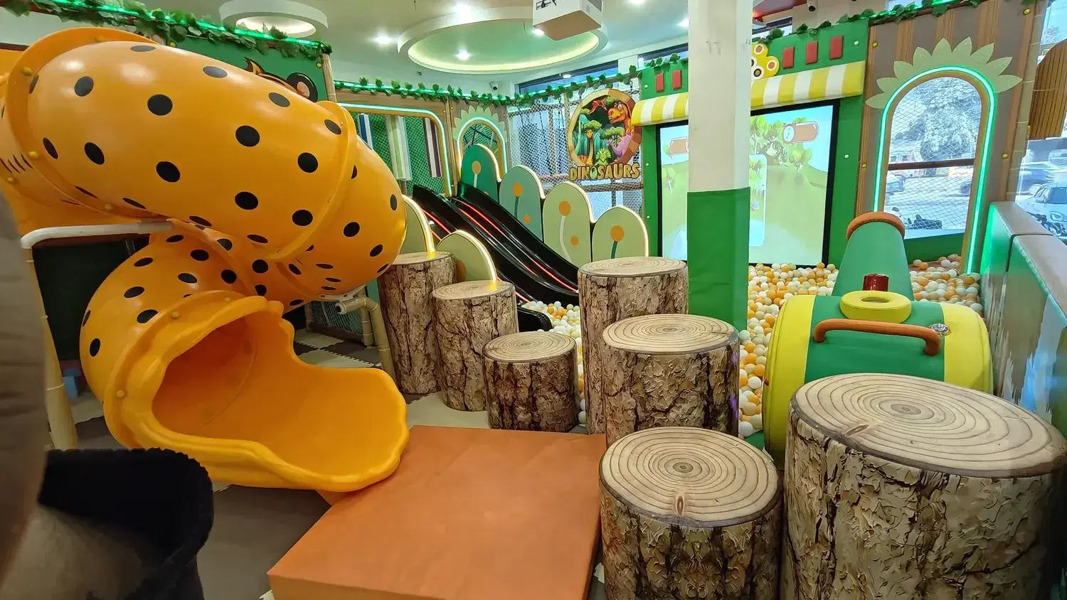 Tunnel slide in the forest-theme play area at Skykids Meerut