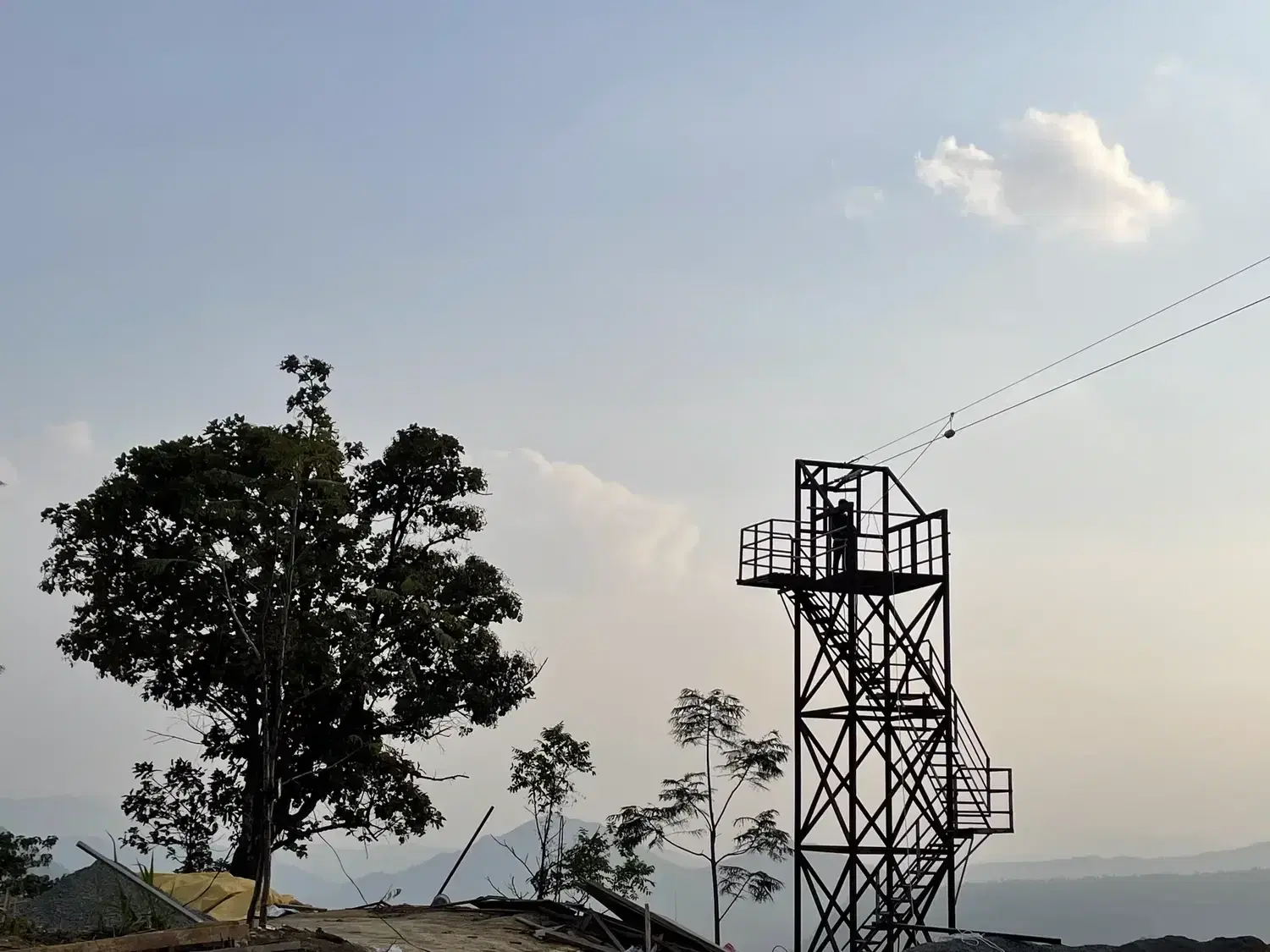 Zipline tower on the contour hilltop at golden hour, Aizawl