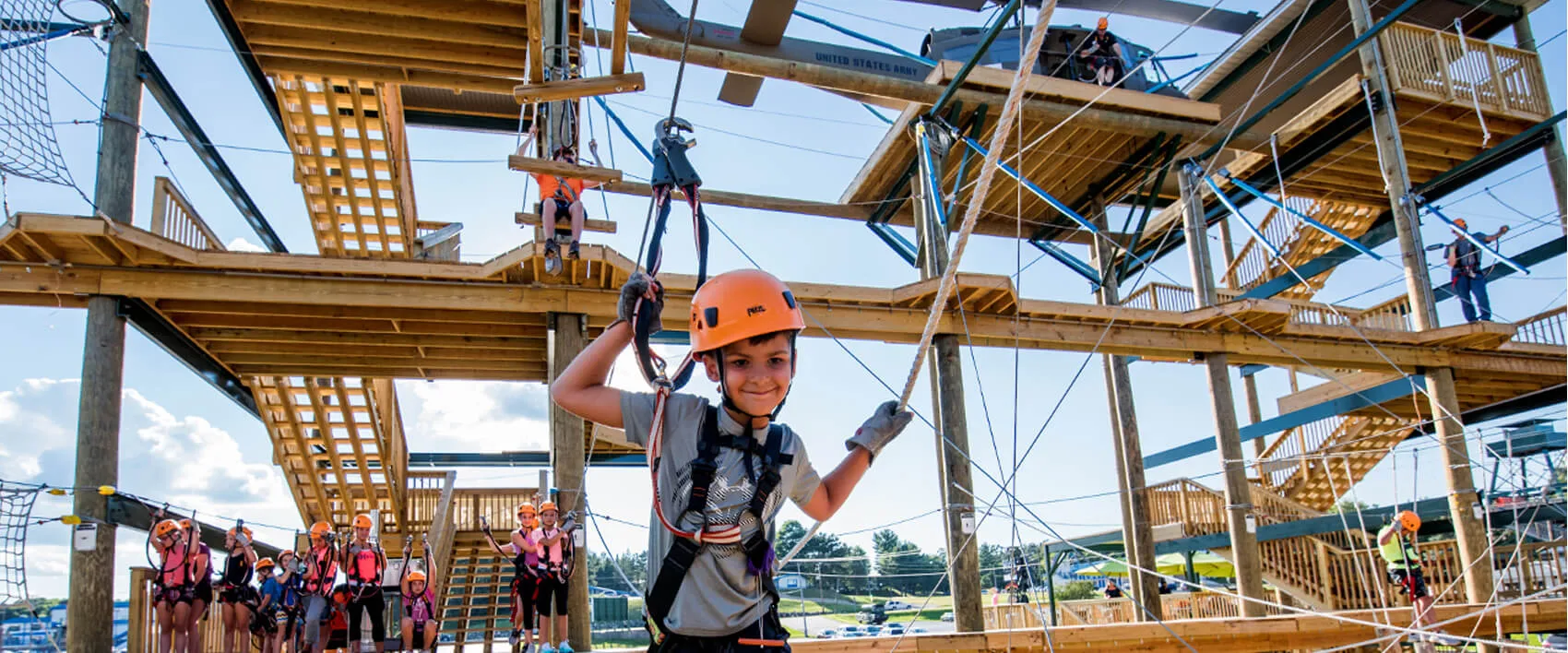 A kid enjoying high rope course designed by best adventure park builders in India