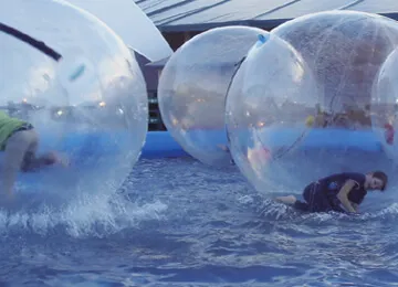 Buy Water zoeb online - Multiple water zorbs in temporary swimming pool