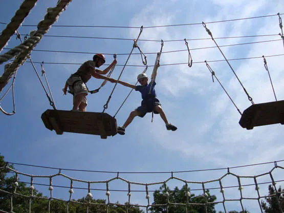 Adventurer with instructor doing high rope course activity